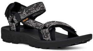 Black sandal with patterned gray, black, and white straps and a black sole.