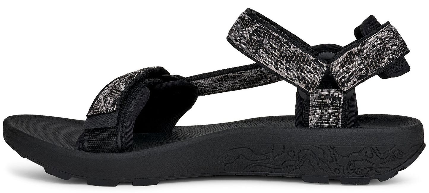 A sandal with black soles and patterned gray and black straps.