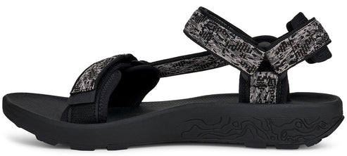 A sandal with black soles and patterned gray and black straps.