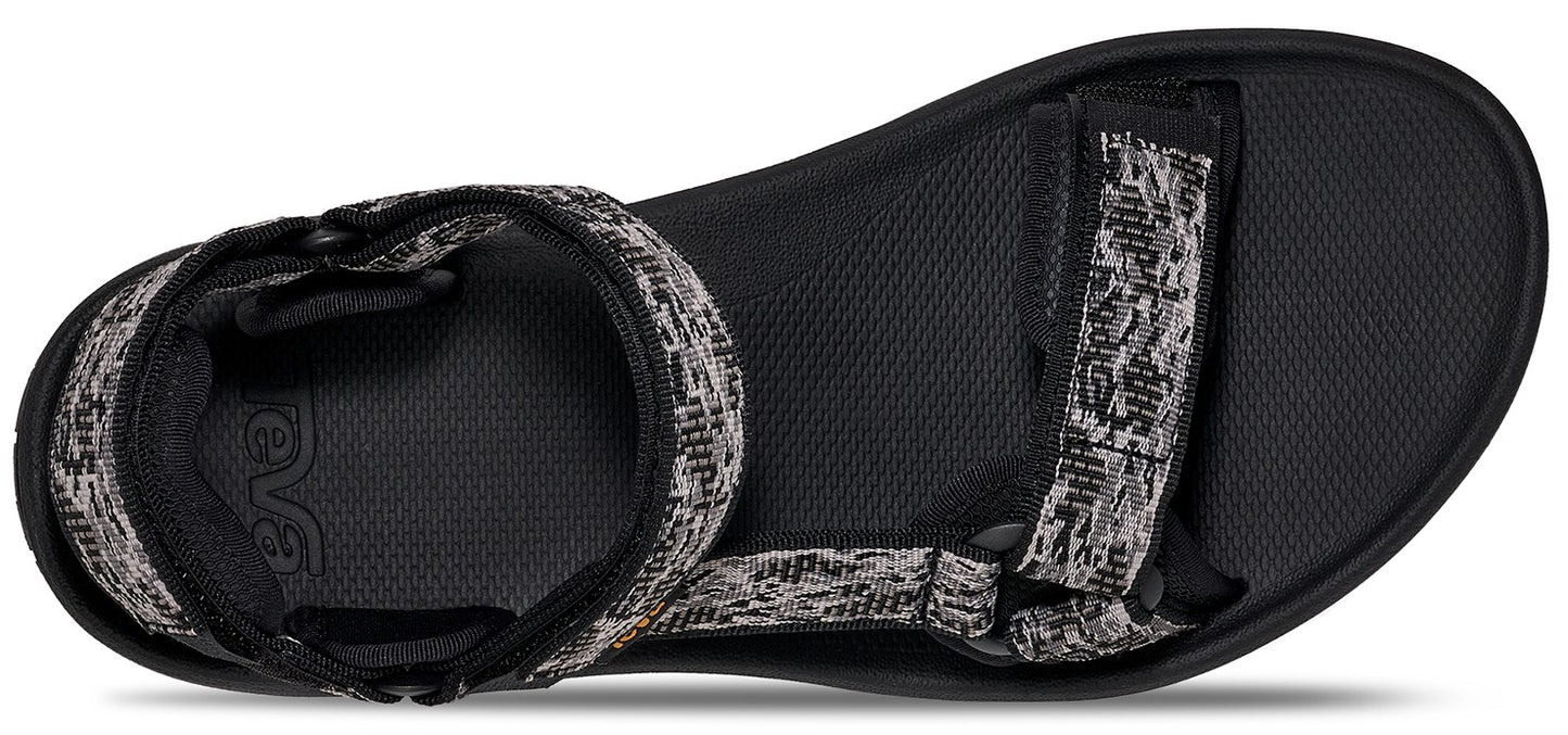 A sandal with woven straps.