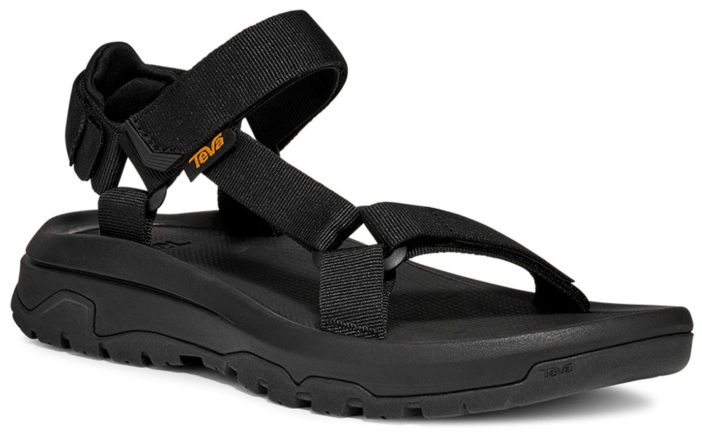 Black sandal featuring adjustable straps and a rugged sole with the text 'TEVA' visible on a tag.