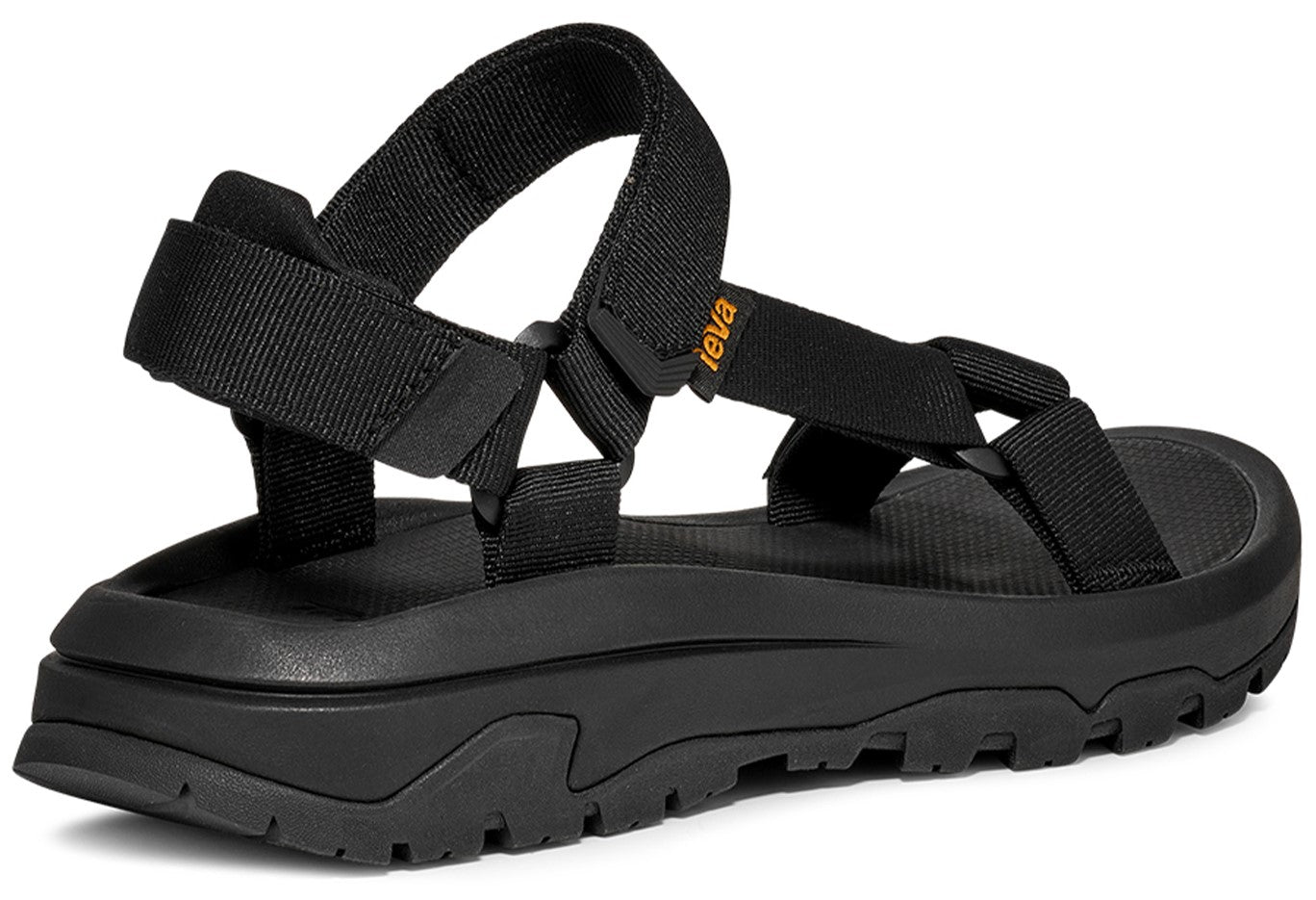 Black sandal with adjustable straps and a thick, lugged sole, 'teva' label visible.
