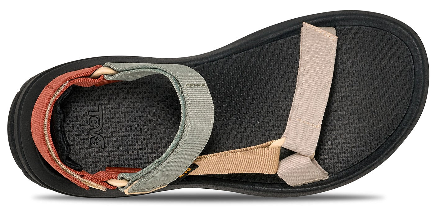 A sandal with textile straps over a black sole.