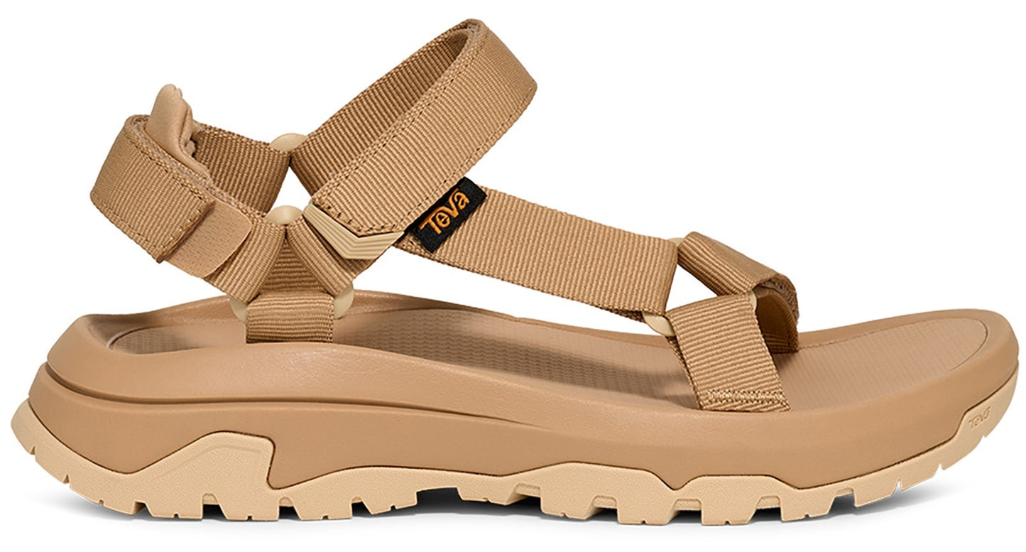 Tan sandal with webbing straps and a rugged sole. "Teva" is visible on the side strap.