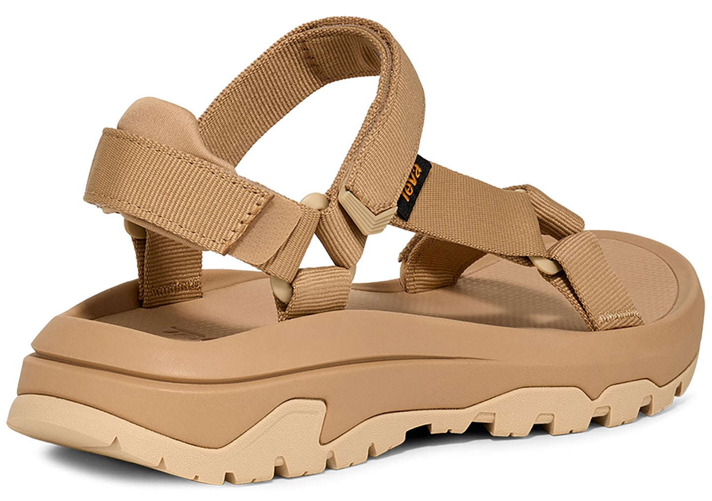 Back of a platform sandal with tan-colored straps and a thick, sculpted tan sole.