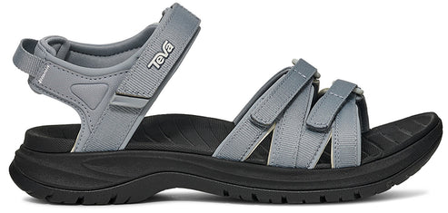A gray sandal with a black sole and TEVA on the side.