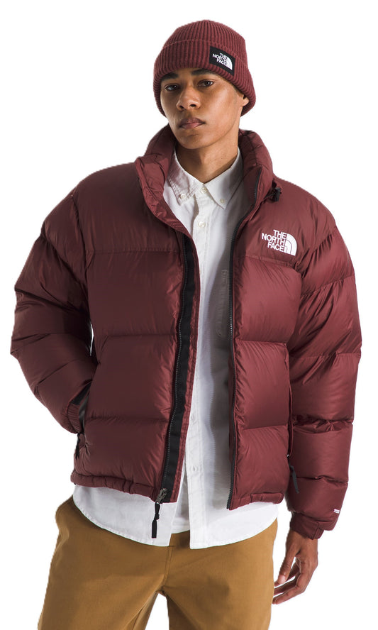 Maroon puffer jacket with beanie, black zipper, and tan pants.