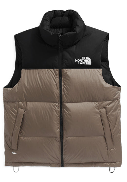 Puffer vest featuring a color block design: black on top and tan on the bottom, with 'The North Face' logo on the chest.