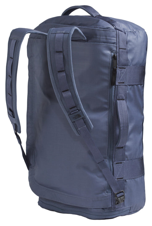Navy duffel bag with shoulder straps and multiple handles.