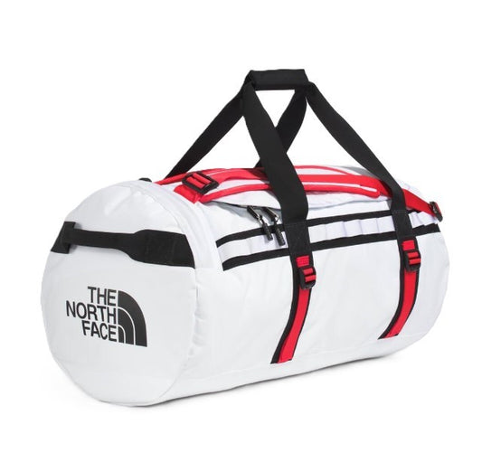 White duffel bag with black straps and red accents showing "THE NORTH FACE" logo.