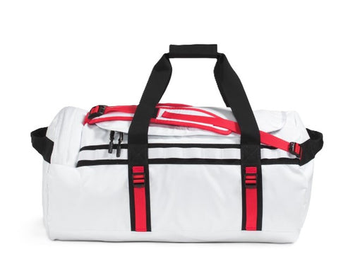 White duffel bag with black handles and red straps.