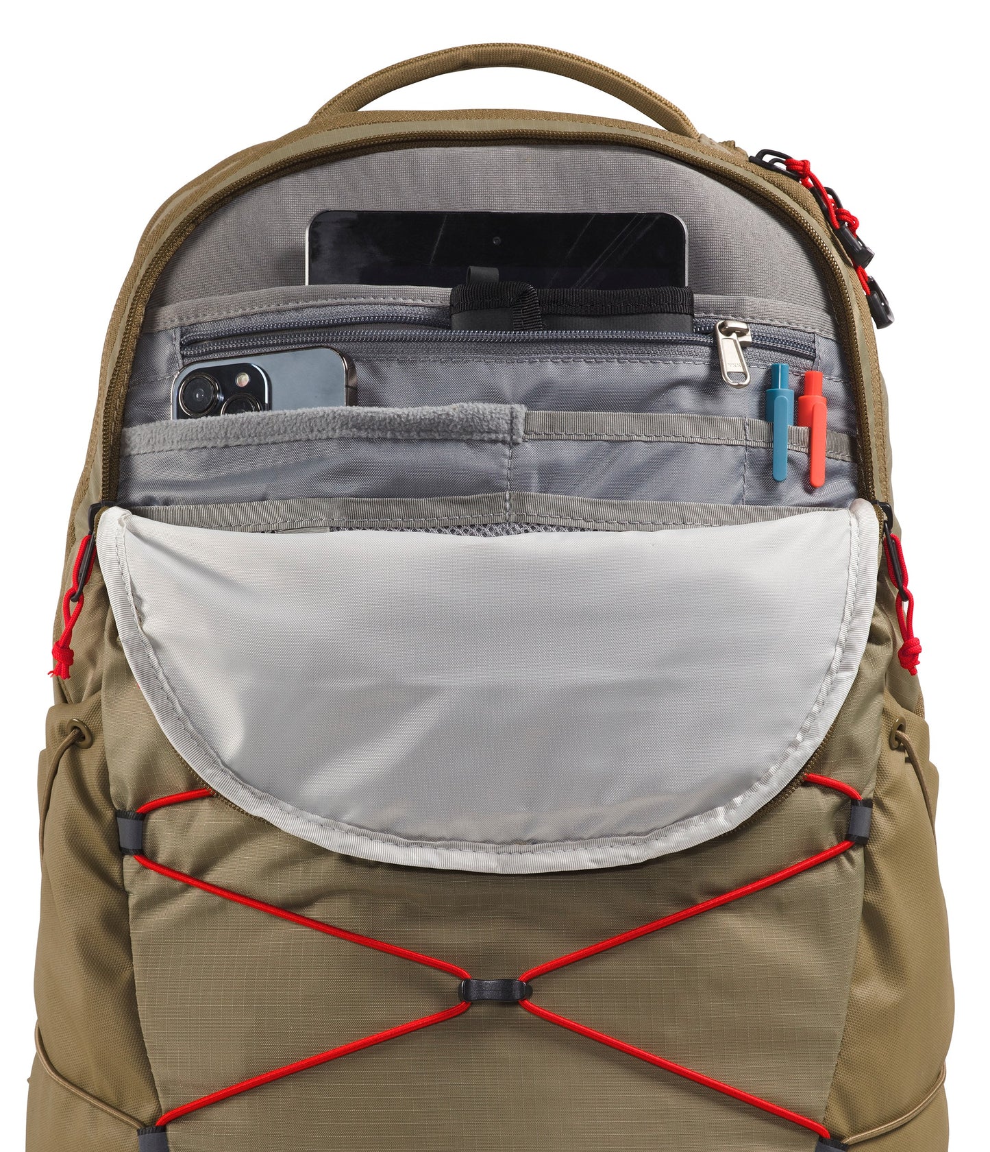 An open tan backpack with a grey interior featuring a top compartment for a tablet, a zippered pocket with a phone, two slots for pens, and a large open pouch, all accented with red zipper pulls and cord detailing on the front.