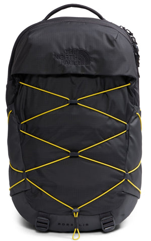 A black The North Face Borealis backpack with a prominent yellow bungee cord system crisscrossing the front, featuring an embossed logo on the top flap and two base straps.