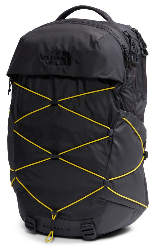 A black backpack with a top handle and a large front pocket, featuring a prominent yellow bungee cord lacing system across the front, with the text 'THE NORTH FACE' subtly embossed on the top flap.