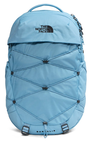 A light blue North Face Borealis backpack with a top handle, bungee cord storage system on the front, and the words THE NORTH FACE and BOREALIS printed on it.