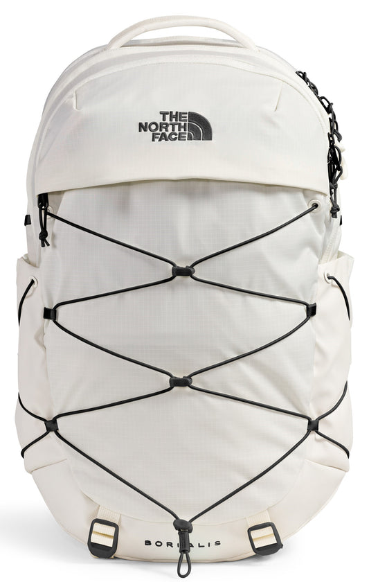 An off-white, cream-colored backpack with a black bungee cord system on the front, featuring a top handle, a zippered compartment, and text printed on the front that reads 'THE NORTH FACE' and 'BOREALIS' at the bottom.