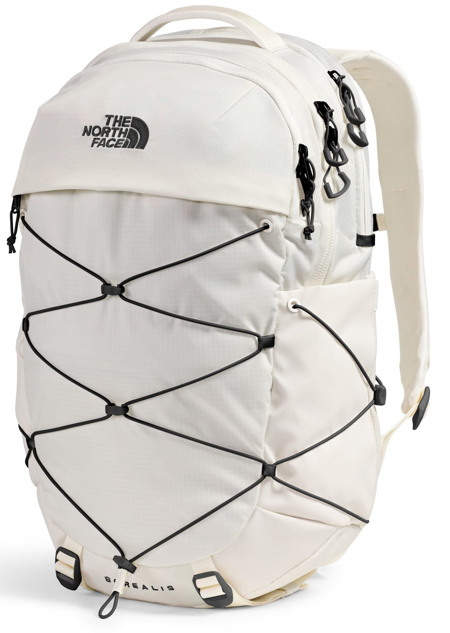 A cream-colored backpack featuring a black crisscross bungee cord system on the front, black zipper pulls, and the text The North Face printed on the top flap.