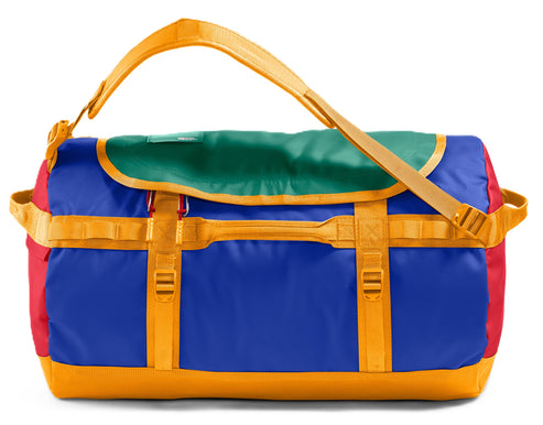 Duffel bag in blue, green, red and yellow with yellow straps.