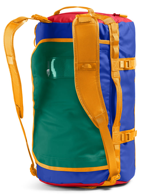 A colorful duffel bag with backpack straps, featuring blue, green, red, and yellow.