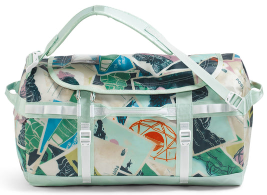 Duffel bag with a colorful vintage postcard print, light green straps and handles.