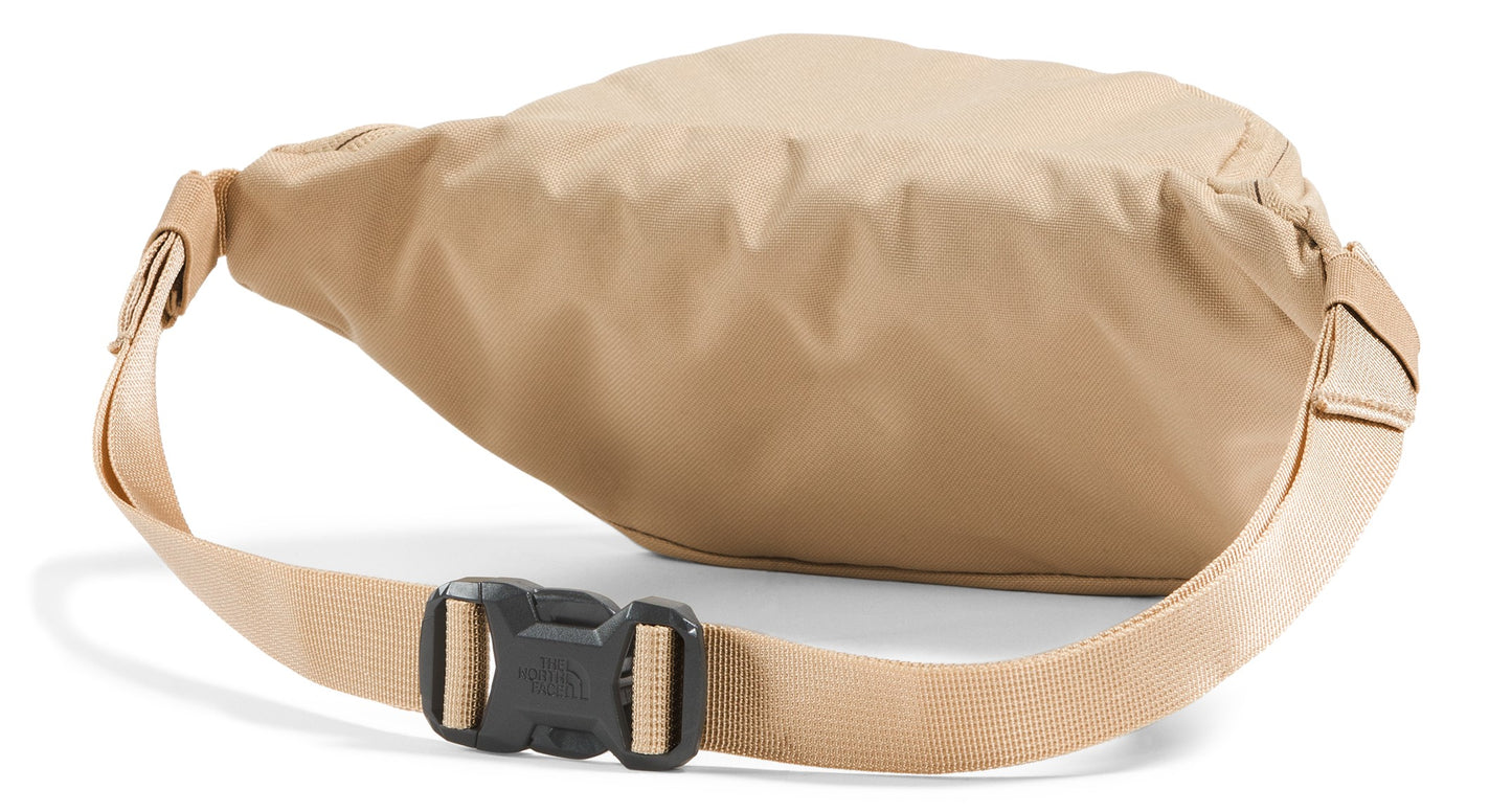 A tan fanny pack shown from the back, featuring an adjustable nylon strap and a black plastic side-release buckle.