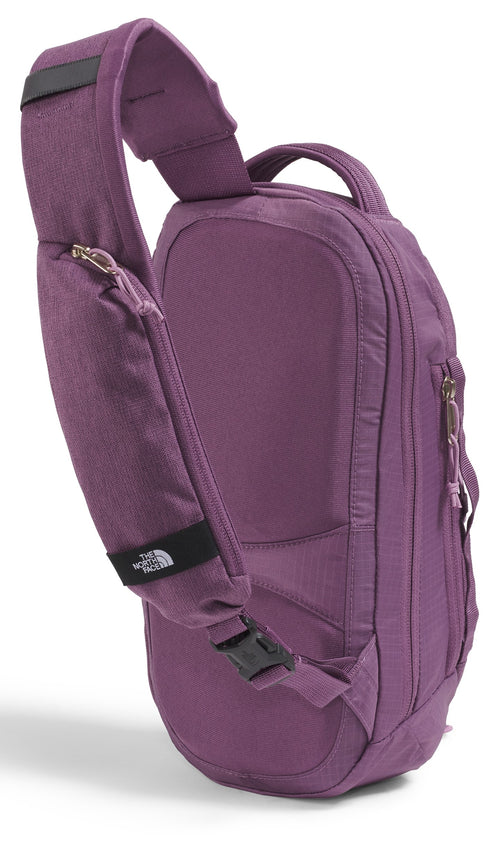 Purple sling backpack with an adjustable shoulder strap and several zippered compartments.