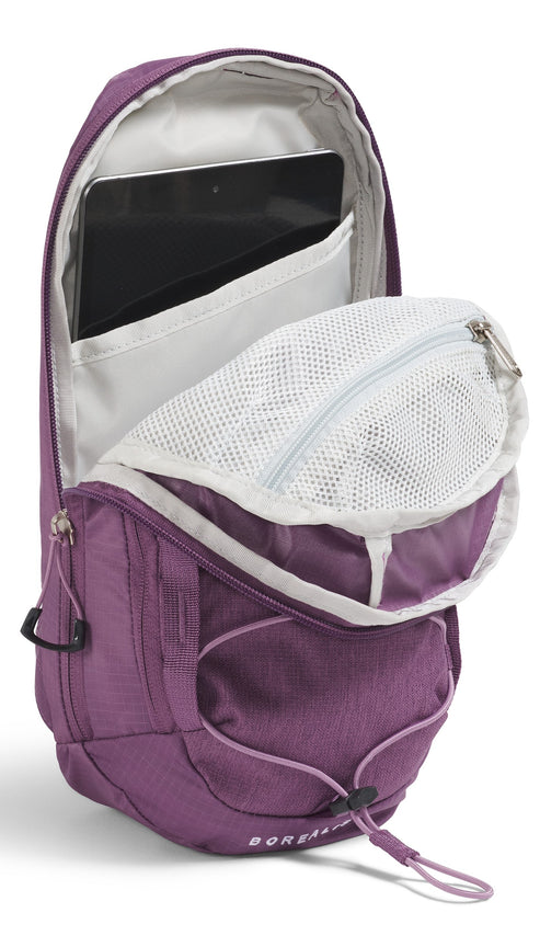 Open purple backpack with tablet inside and mesh pocket visible.