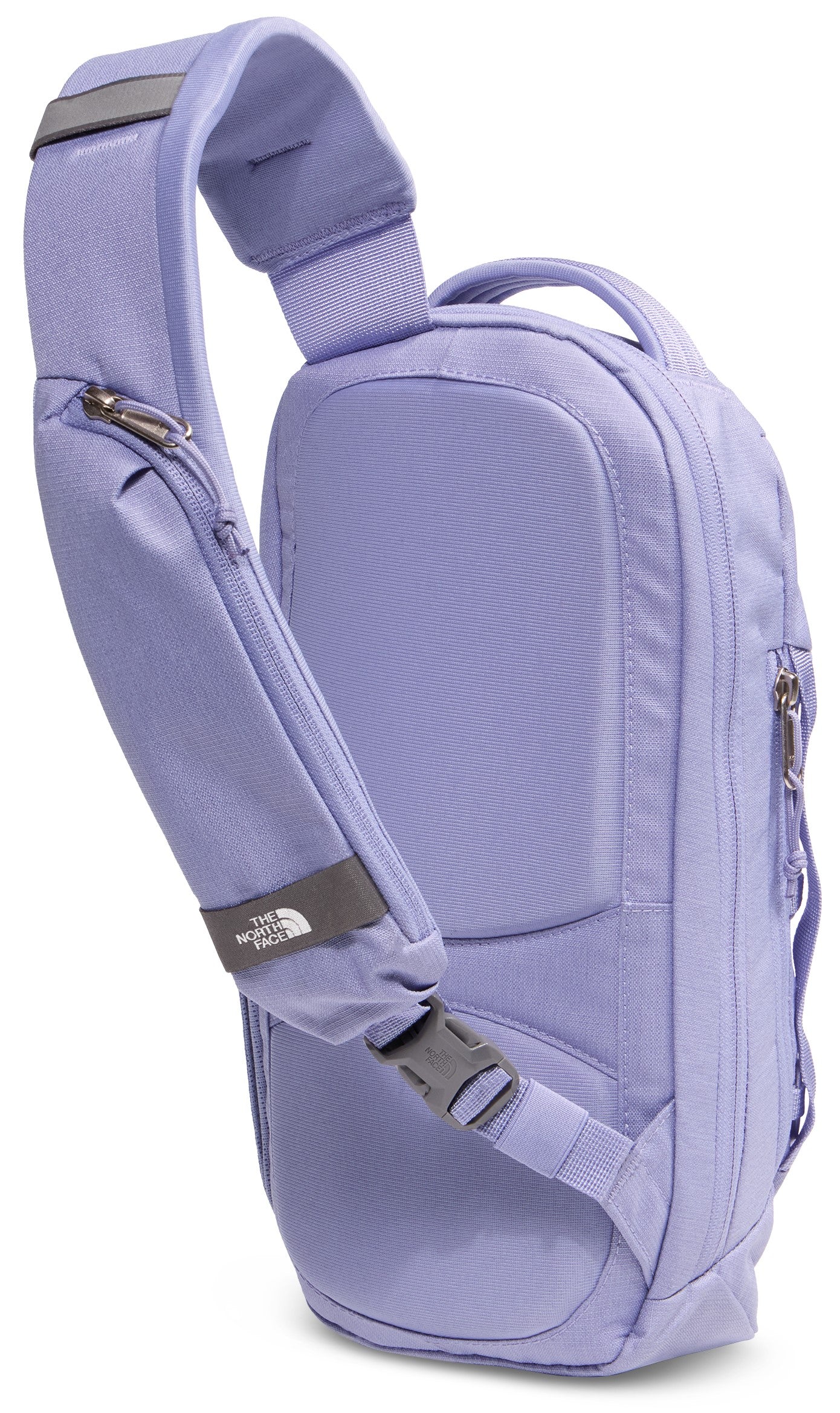 A light purple, single-strap sling backpack shown from the back, featuring a padded back panel, a single adjustable shoulder strap with a zipper pocket and The North Face logo, and a side zipper closure.