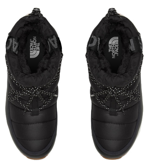 A pair of black, puffy, snow boots with a drawstring, and "The North Face" printed on the insole.