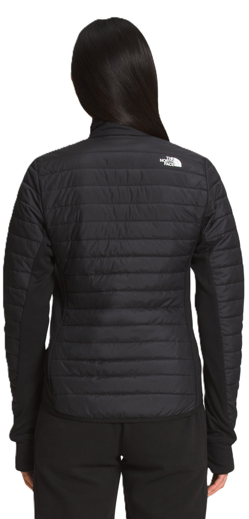 The back view of a hooded black jacket with quilted padding on the torso and smooth fabric on the sleeves and hood.