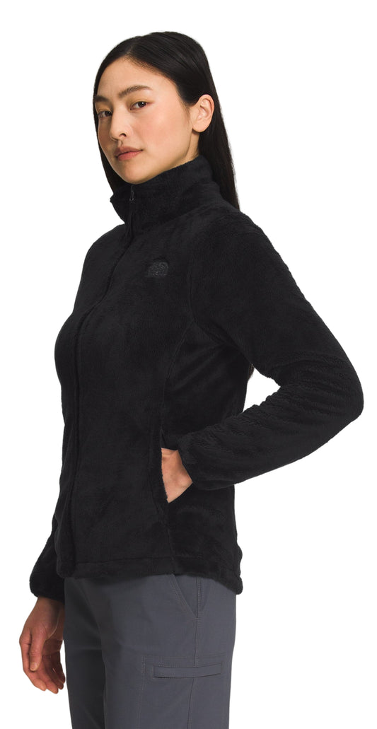 A woman wearing a black fleece jacket with a zipper closure and pockets.
