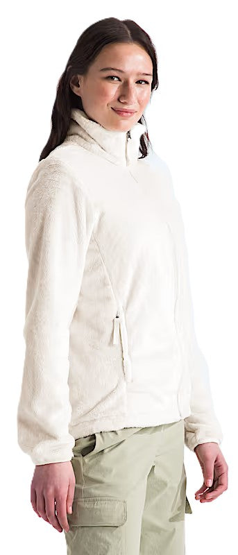 A person wears a cream-colored fleece jacket and khaki pants.