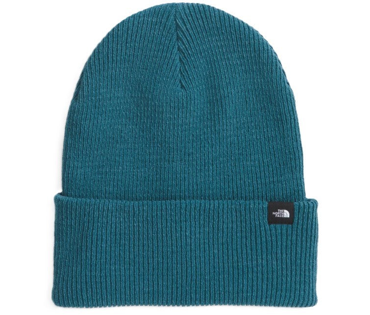 Teal knit beanie with folded brim and small black logo tag.