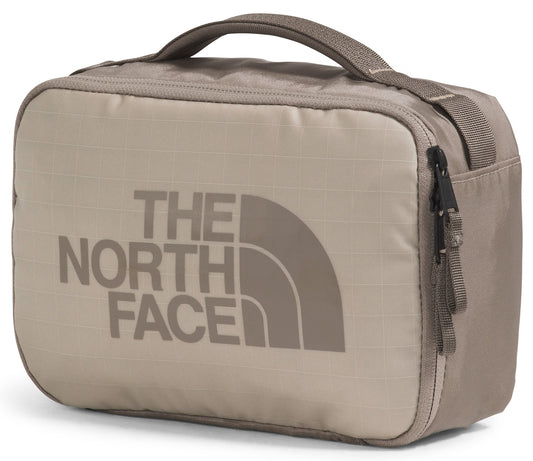 Tan toiletry bag with a handle and 'THE NORTH FACE' printed in large gray letters.