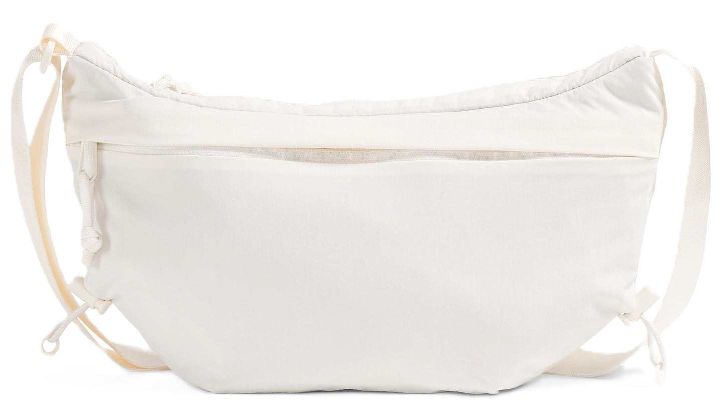 An off-white puffy curved shoulder bag with a front zipper pouch, drawstrings on each side, and an adjustable shoulder strap.