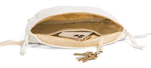 A white bag open with keys, and a phone visible inside.