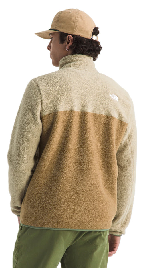 Person wearing a color-blocked fleece with a zipper and matching cap.