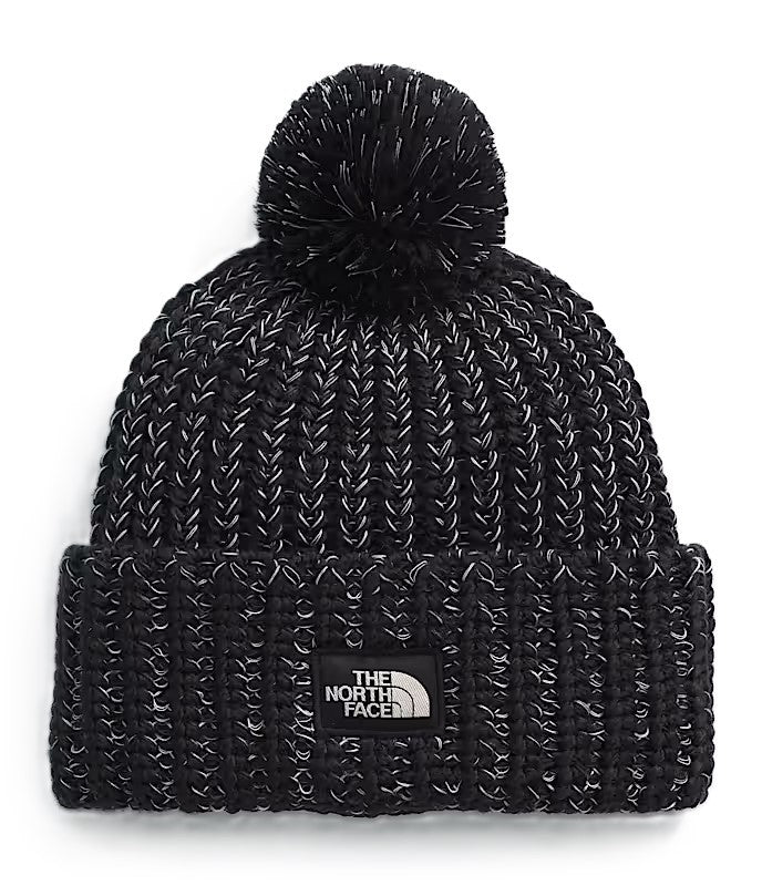 Black knit beanie with a pompom on top and a square patch with "THE NORTH FACE" on the front