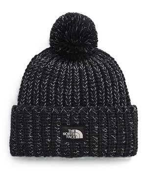 Black knit beanie with a pompom on top and a square patch with "THE NORTH FACE" on the front