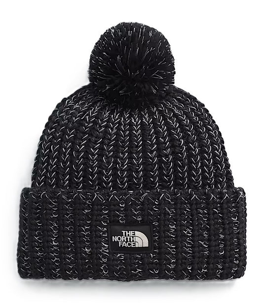 Black knit beanie with a pompom on top and a square patch with "THE NORTH FACE" on the front