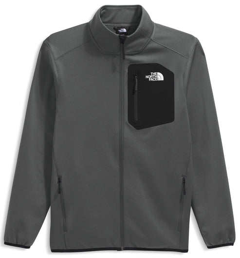 A gray zip-up softshell jacket featuring a black chest pocket with the brand logo and two zippered side pockets.
