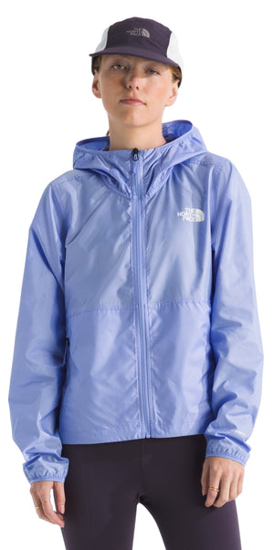 A person wearing a light blue hooded jacket and a dark-colored baseball cap.