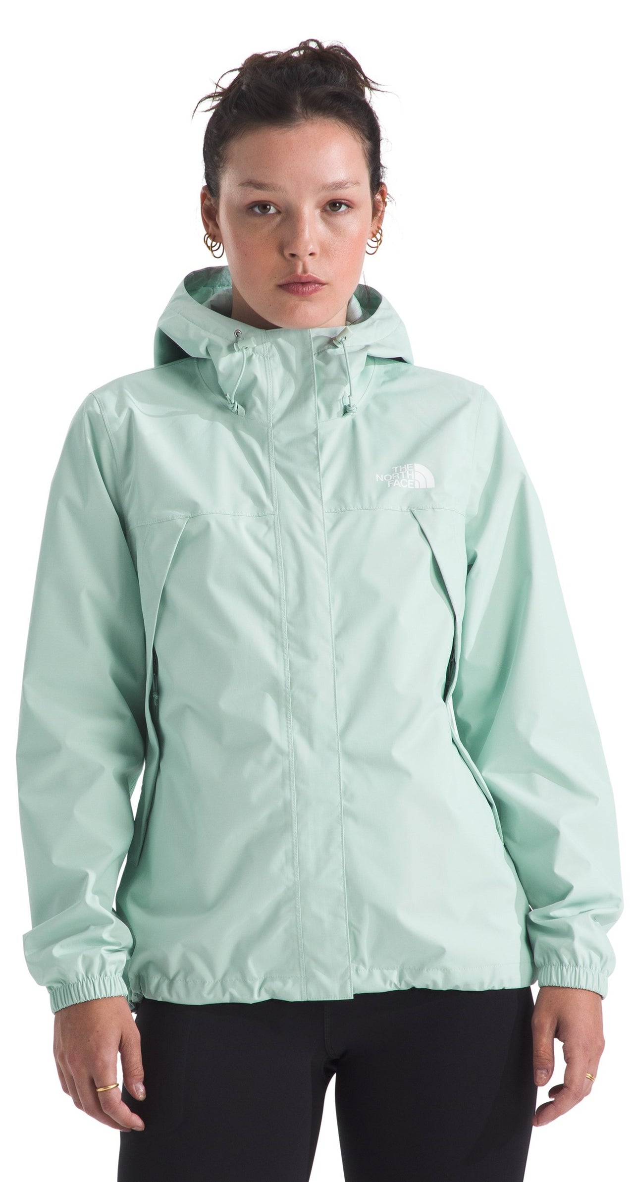 A person wearing a light green hooded jacket.