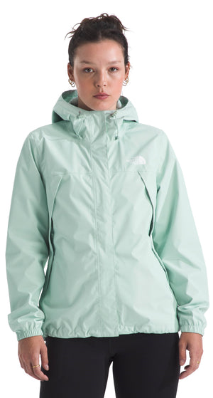 A person wearing a light green hooded jacket.