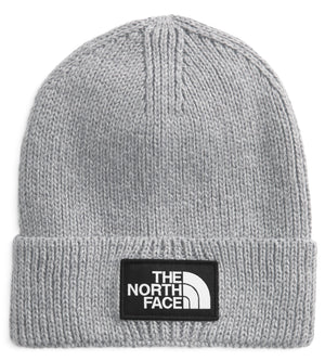 A light gray knit beanie with a black patch on the front that says THE NORTH FACE in white.