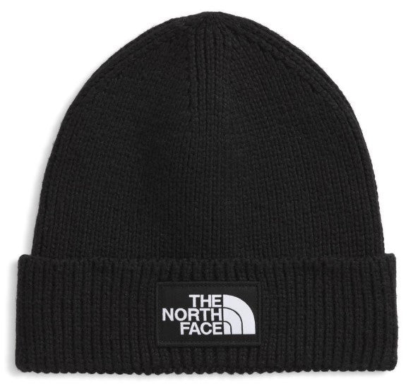 Black knit beanie with a rectangular patch on the folded brim displaying the words "THE NORTH FACE" above a white half-dome logo.