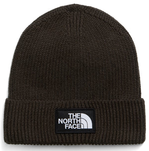 A dark olive green knit beanie with a folded cuff and a rectangular black patch on the front featuring the white text "THE NORTH FACE" and a logo symbol.