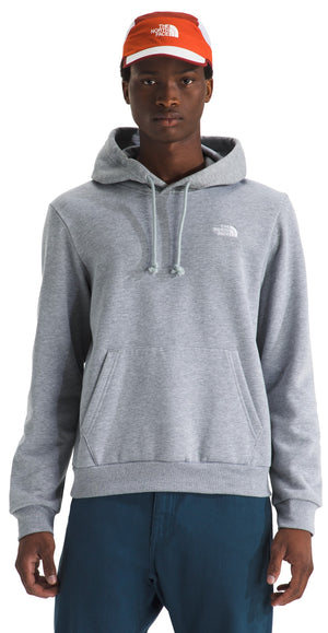A man wearing a grey hooded sweatshirt with a small white logo on the chest and an orange and white baseball cap.