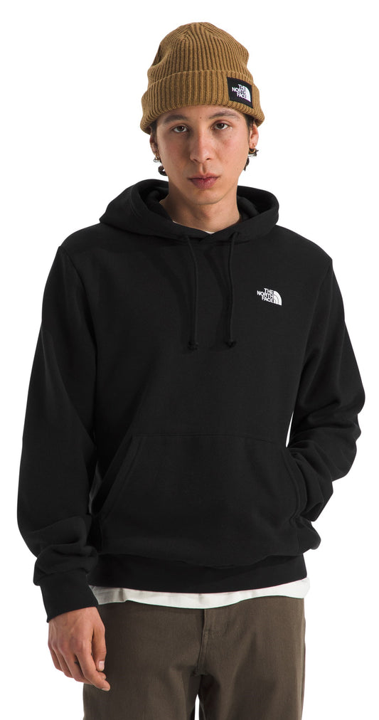 A person wearing a black hooded sweatshirt and a tan beanie.