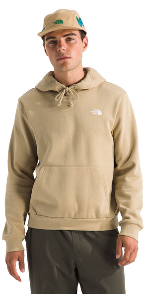 A man wearing a light brown hoodie and a matching hat with the North Face logo.